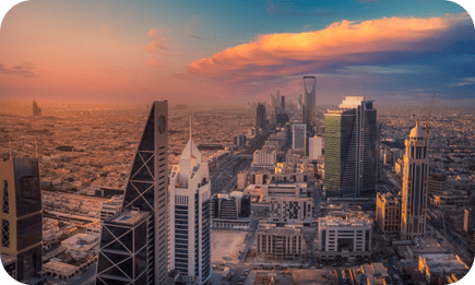 Sunset over Riyadh's skyline with iconic skyscrapers.