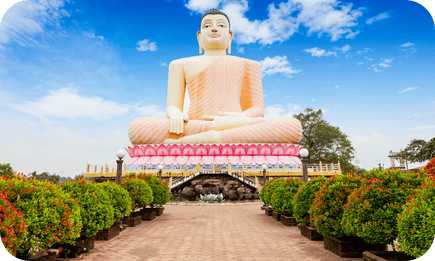 Majestic Buddha statue in Sri Lanka against a clear blue sky