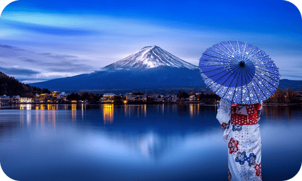 Person in kimono overlooking Mount Fuji at dusk in Japan