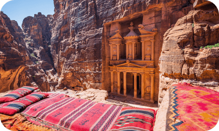 Al-Khazneh, the Treasury at Petra, with traditional Bedouin cushions in the foreground.